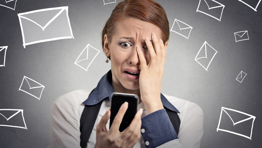 Upset stressed woman holding cellphone disgusted shocked with message she received isolated grey background. Funny looking human face expression emotion feeling reaction life perception body language