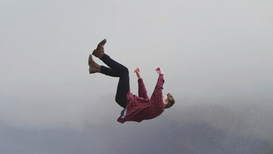 A man in a plaid shirt falling