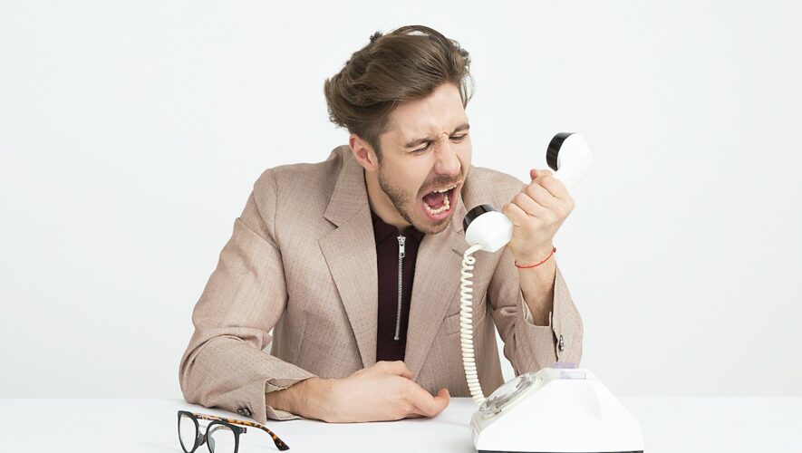 an angry guy yelling into phone