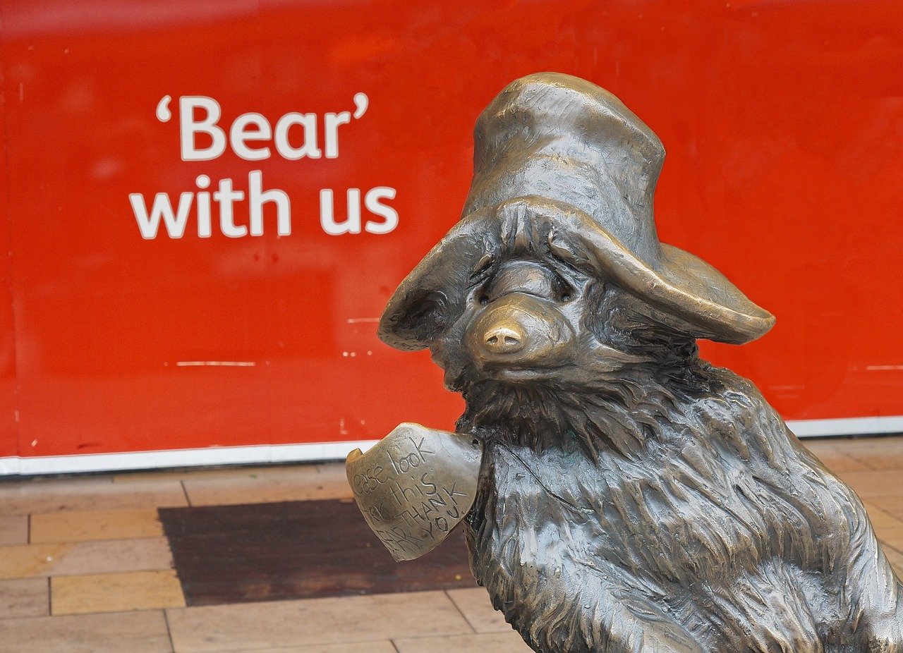 'bear with us' with Paddington statue