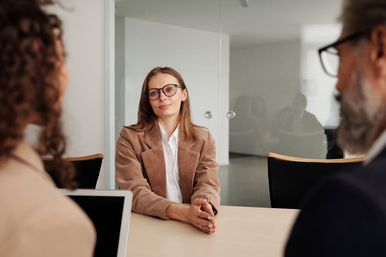 woman with glasses being interviewed for a job